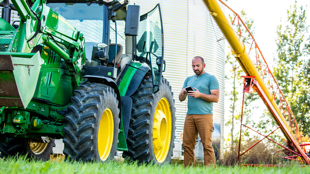 A farmer looking at his smart phone