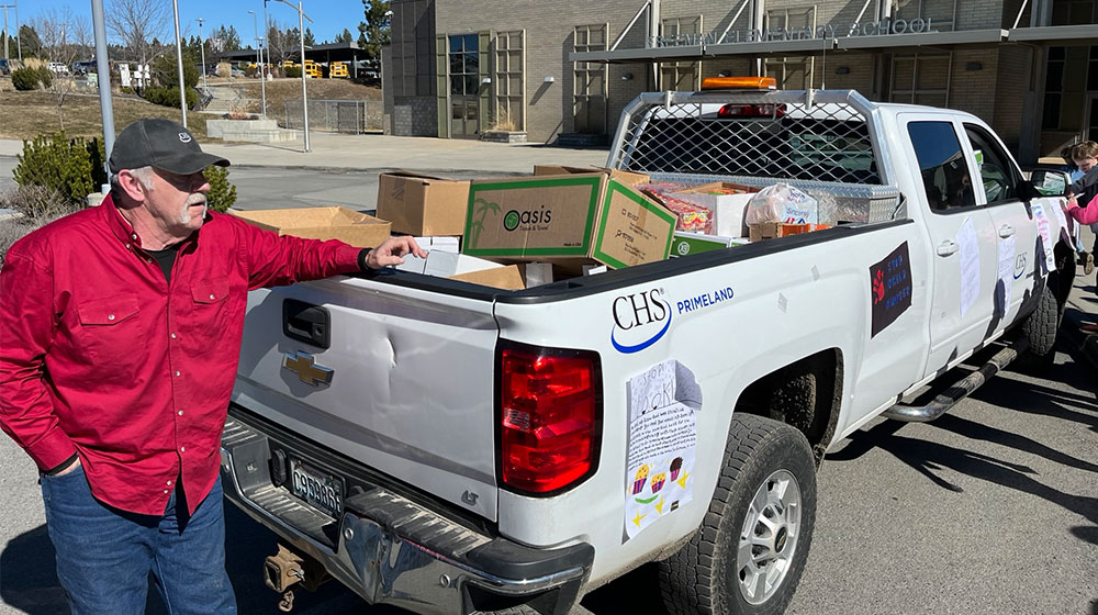 man leaning on CHS truck