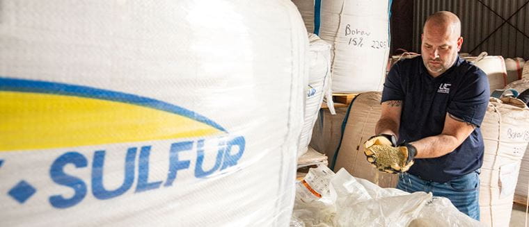 Man holding granular fertilizer