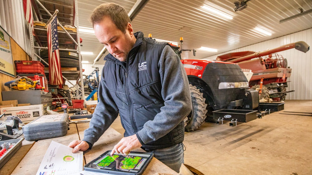 Man in farm shop looking at tablet