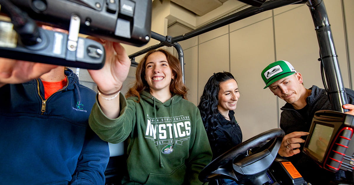 Four people testing precision ag equipment.