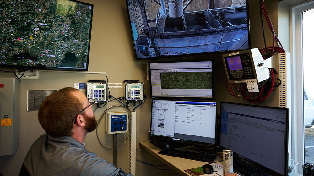 man sitting at a control panel