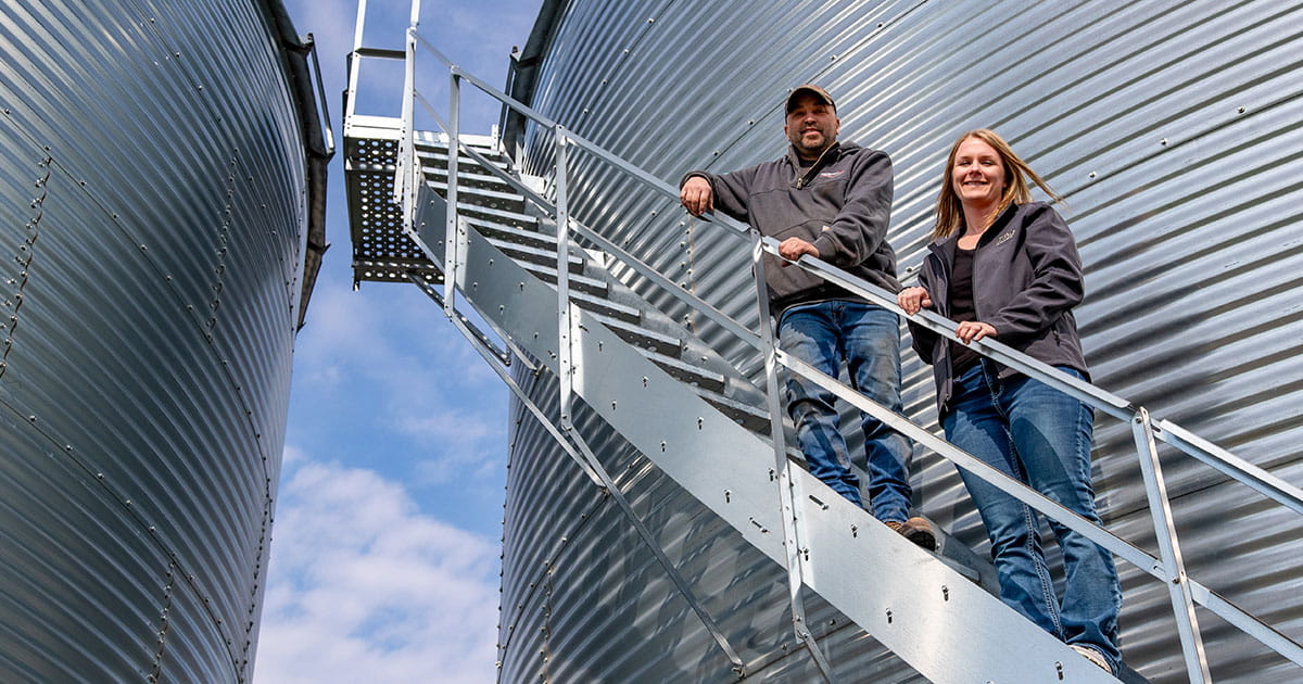 Man and woman on grain bin stairs