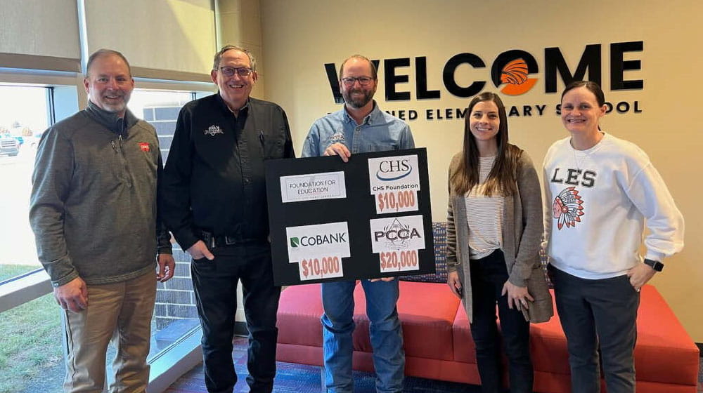 Three men and two women holding up a sign with Foundation for Education grants
