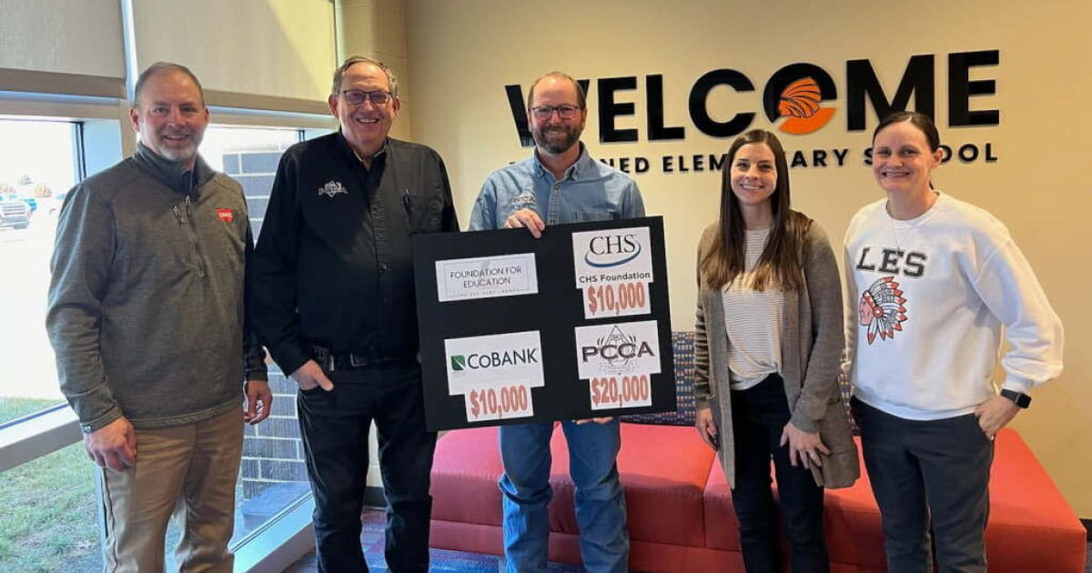 Three men and two women holding up a sign with Foundation for Education grants
