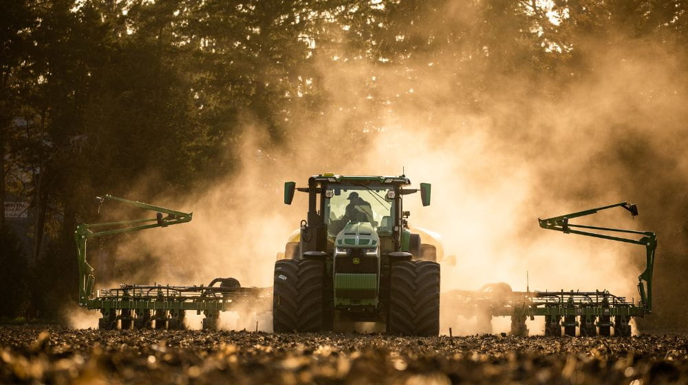 A tractor and planter in a field. 