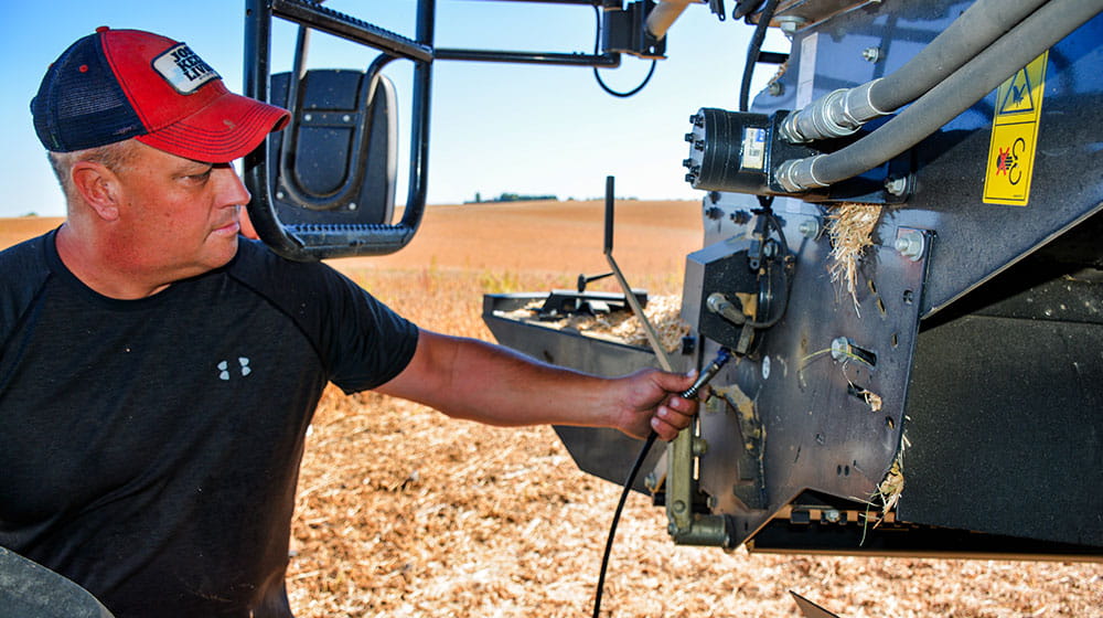 Two men talking by a tractor.
