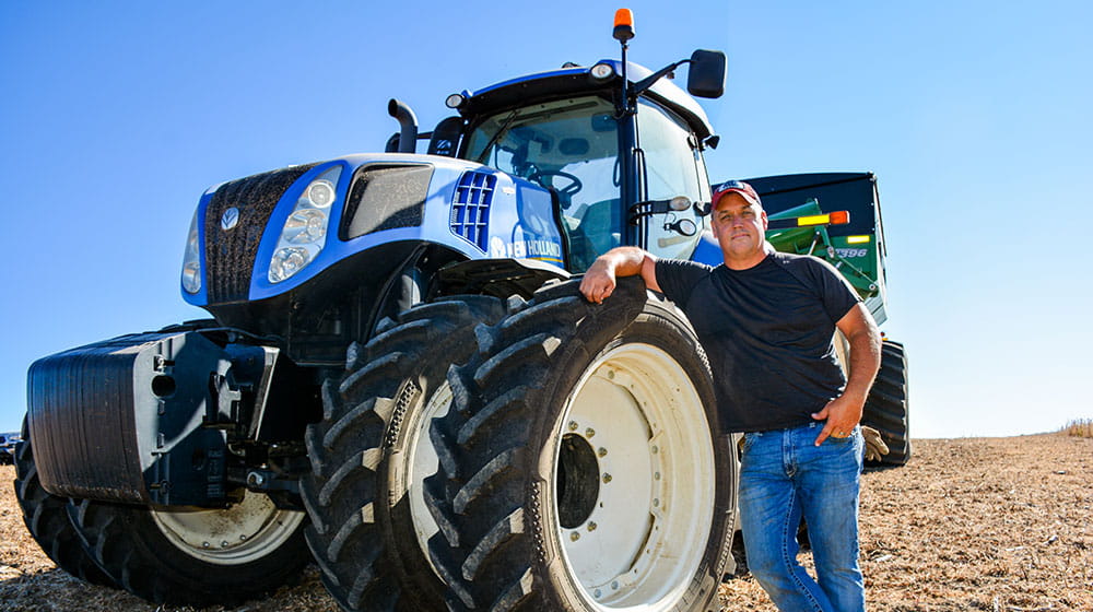 Man standing by a tractor.