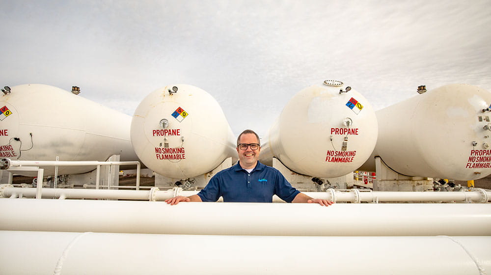 Man standing by propane tank.