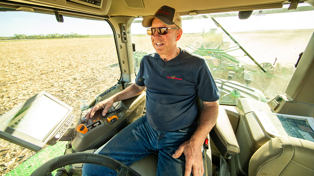 Man in tractor pulling a planter