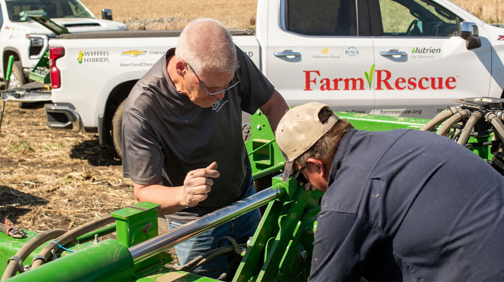 Two men fixing a planter