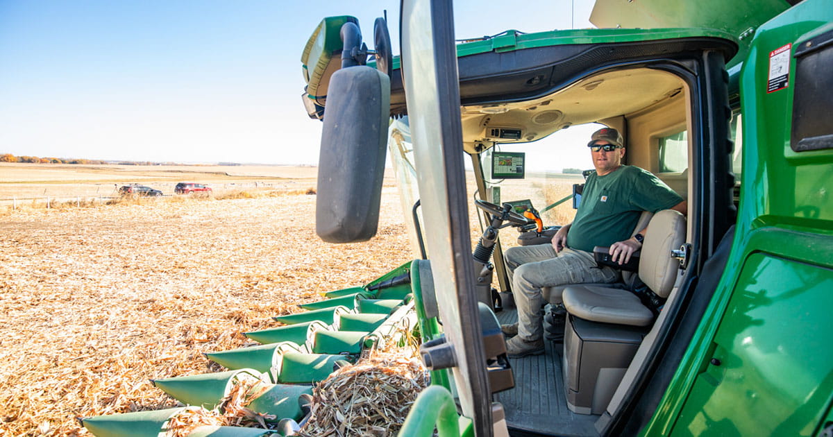 Farmer sitting in a combine in a field