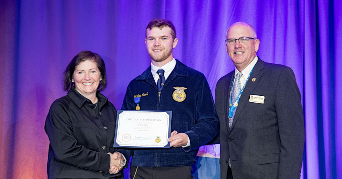 Three people accepting an award.