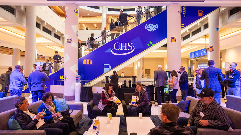 People sitting on couches in a convention center.