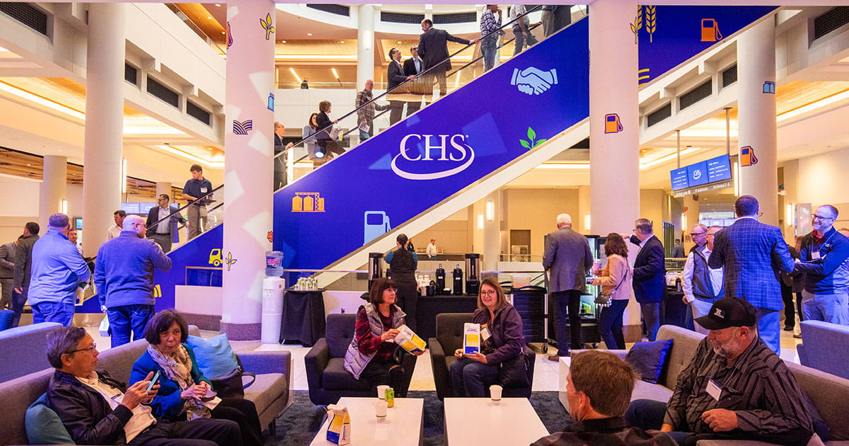 People sitting on couches in a convention center.