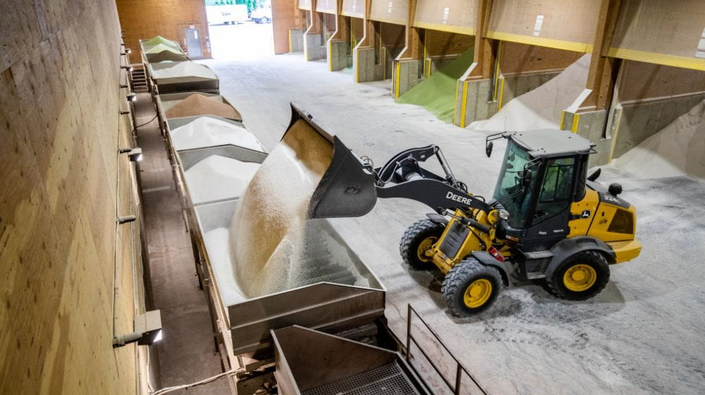 Fertilizer being moved around in a shed. 