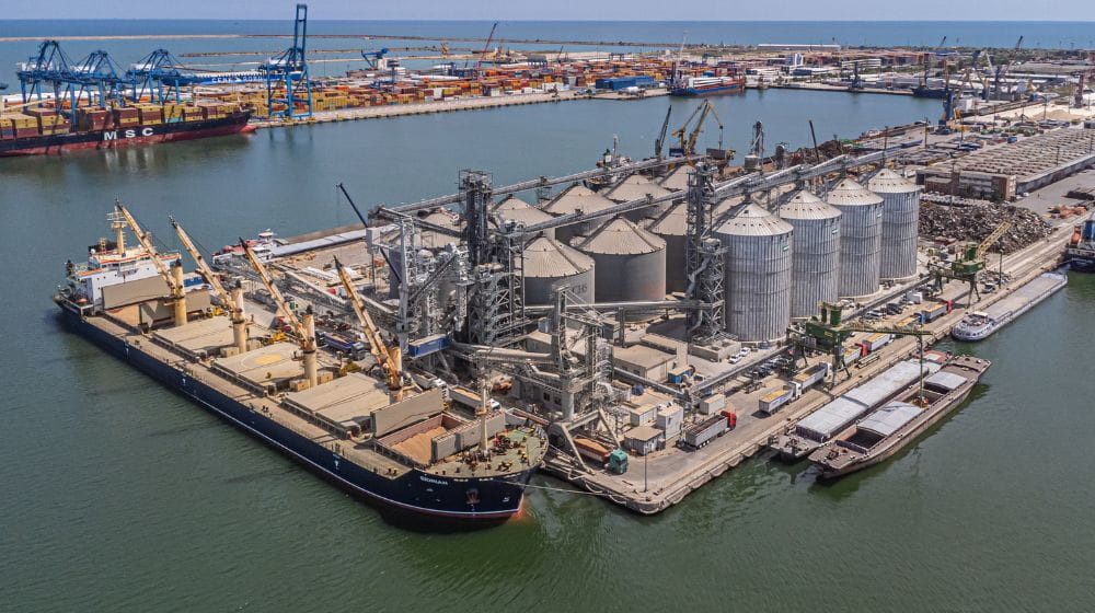 Ship being loaded with grain at export terminal.