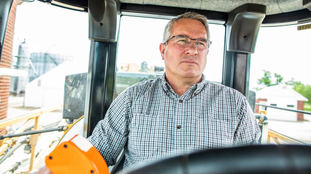 Dan Schurr in a cab of a tractor.