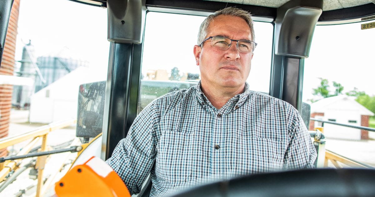 Dan Schurr in a cab of a tractor.