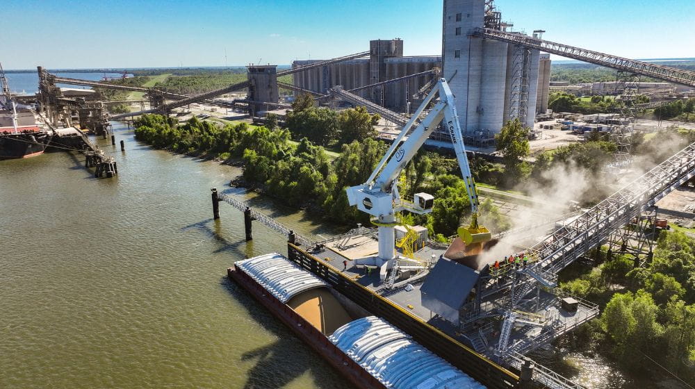 Aerial image of a barge next to a facility. 