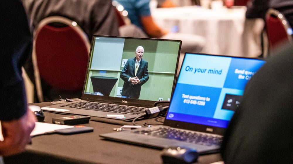 Two computer screens showing a virtual meeting. 